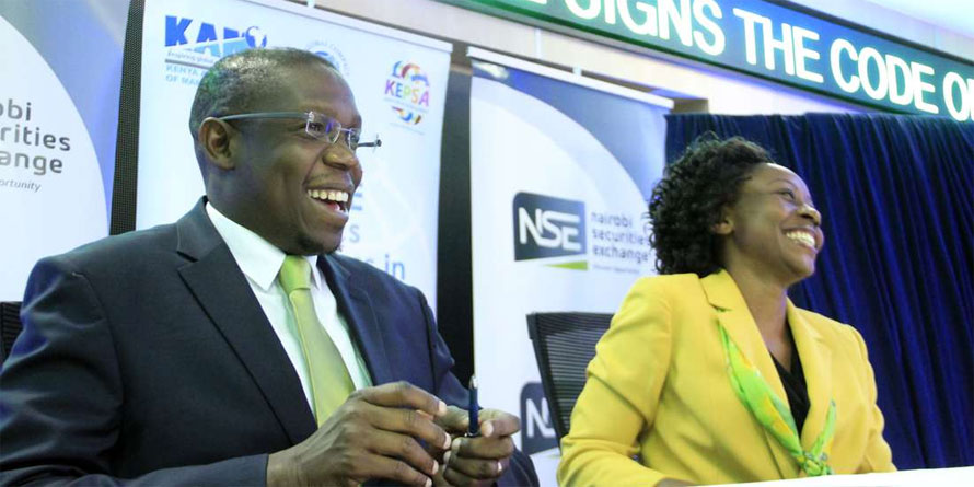Nairobi Securities Exchange CEO Geoffrey Odundo with Kenya Association of Manufacturers CEO Phyllis Wakiaga during the signing of the Code of Ethics for Business in Kenya report last year. PHOTO | DIANA NGILA | NMG